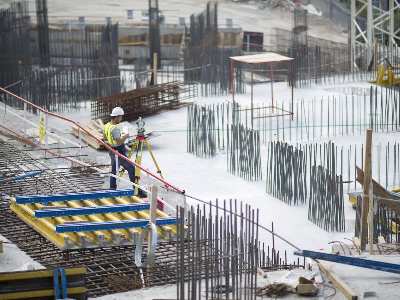 man-making-measurements-building